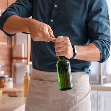 Man uses bottle opener.
