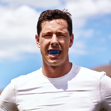 Man wears athletic mouthguard.