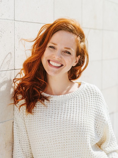 Woman smiling outside.